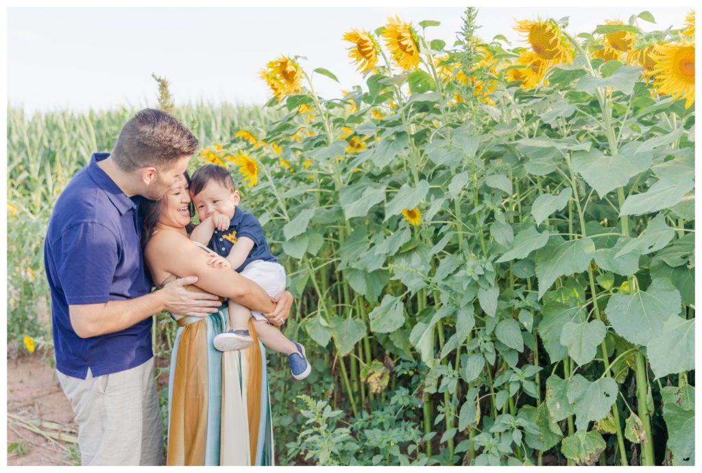 Summer Sunflower Family Photos Frederick MD - mother and father laughing with baby boy