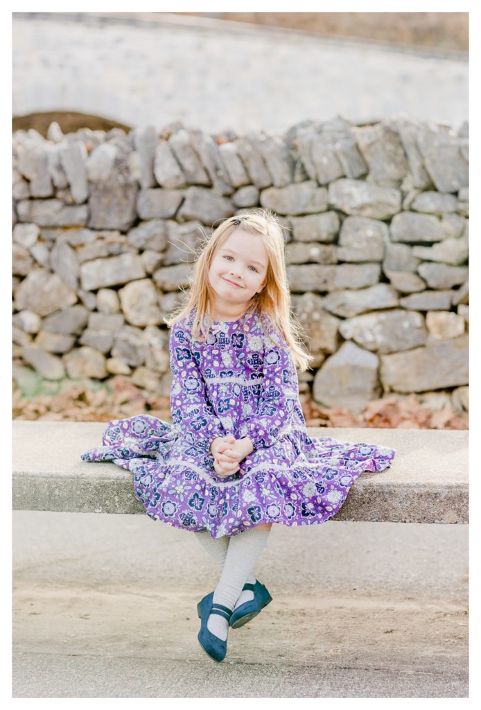 Fall Family/Lifestyle Photography Antietam MD - photo shoot little girl smiling in front of historic stone wall at Antietam Battlefield