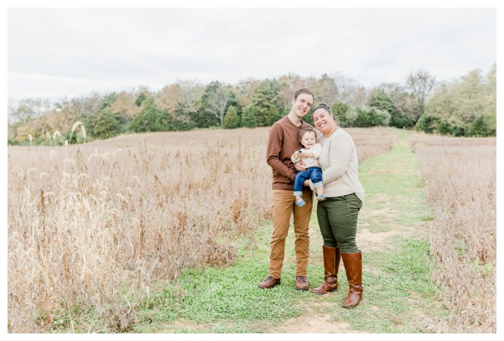 Fall Family Photos Antietam Maryland - mom and dad smiling with baby girl in a field