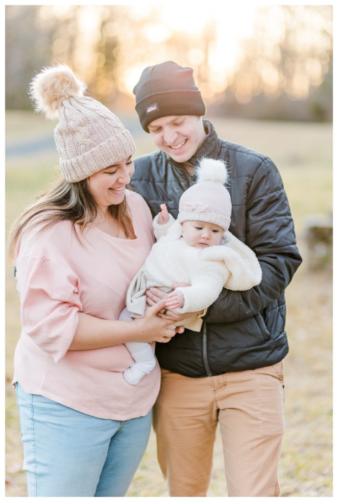 Winter Family Photos at Sugarloaf Mountain in Maryland - mom and dad looking at baby girl