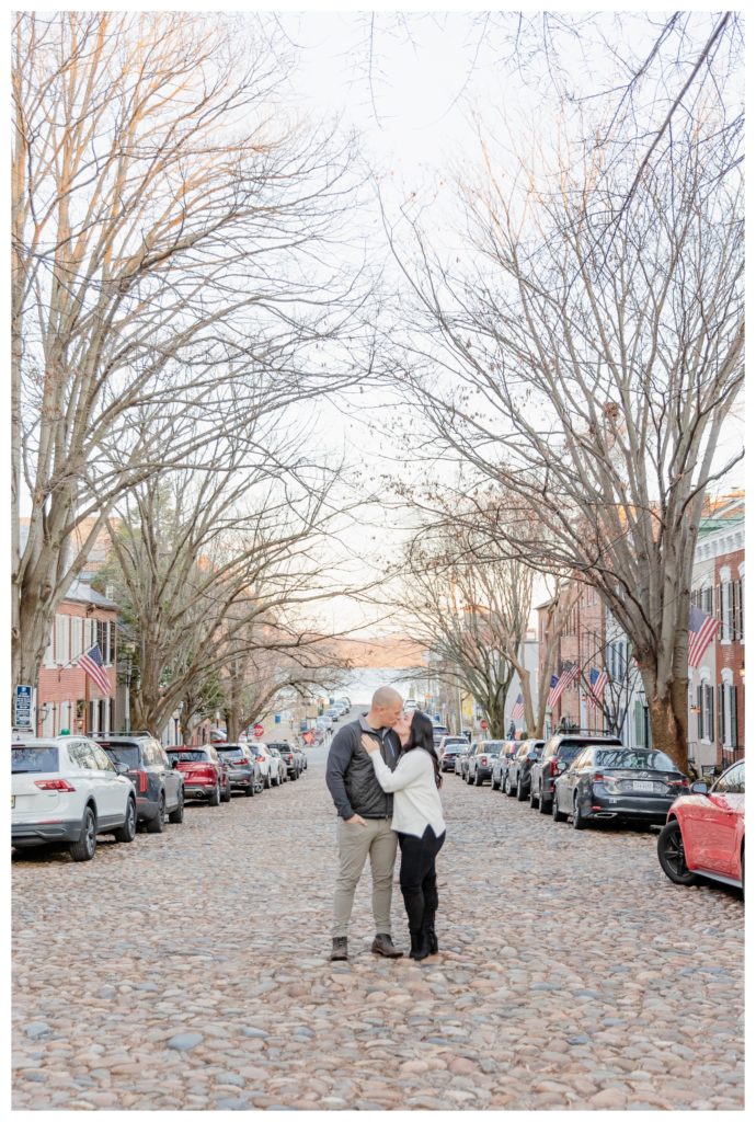 Winter Engagement Photos Alexandria VA Waterfront - couple kissing on cobblestone street