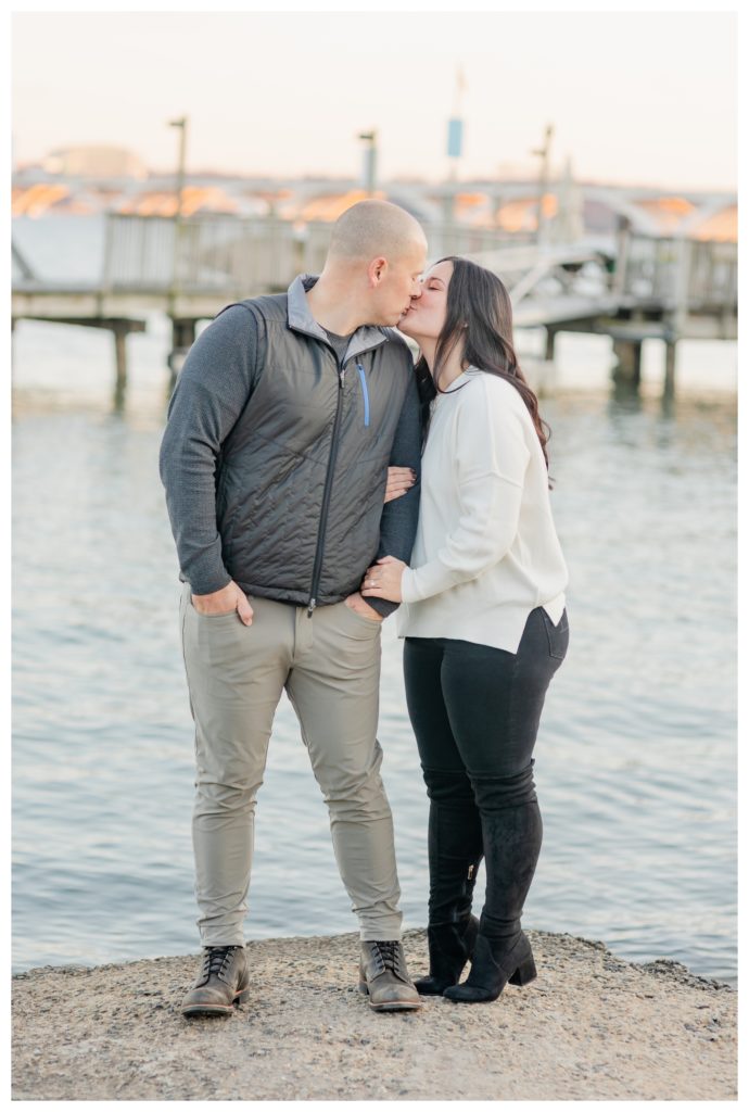 Winter Engagement Photos Alexandria VA Waterfront - couple kissing in front of dock