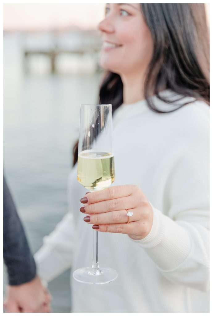 Winter Engagement Photos Alexandria VA Waterfront - woman smiling with engagement ring and champagne