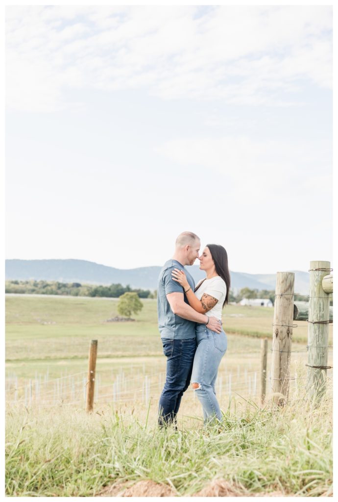 Autumn Vineyard Engagement Session - engaged couple sharing an embrace in a field