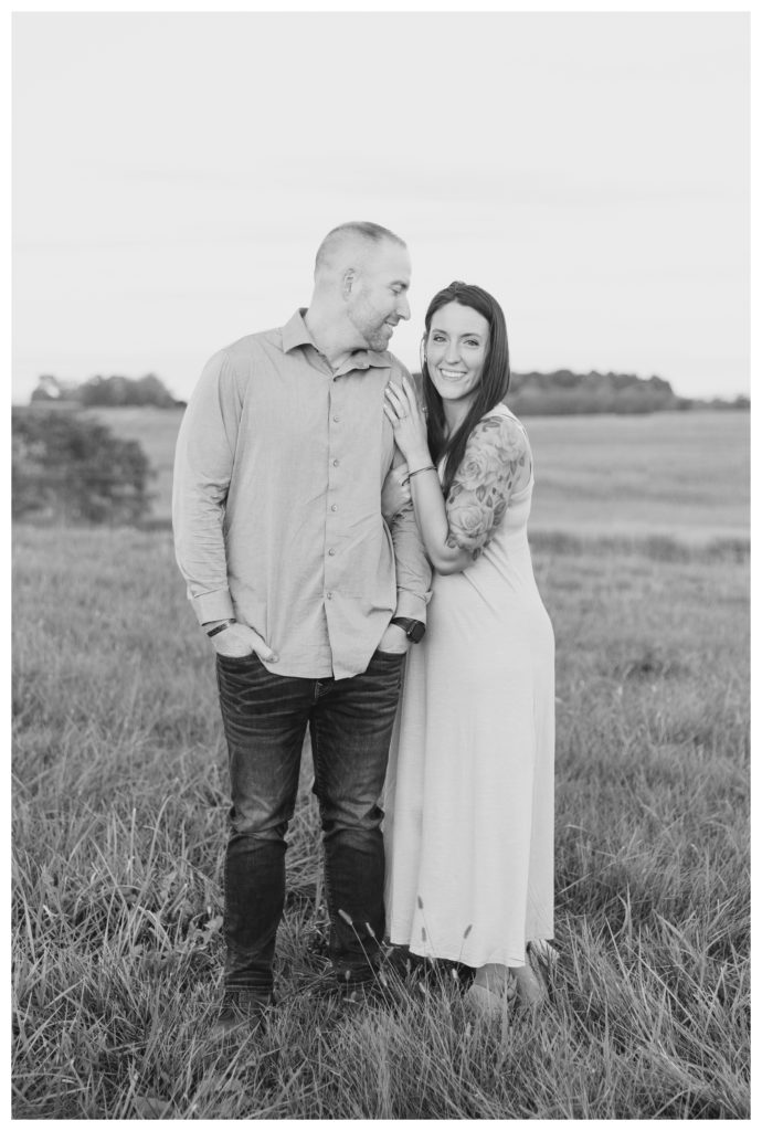 Autumn Vineyard Engagement Session - black and white photo of a couple smiling in a field